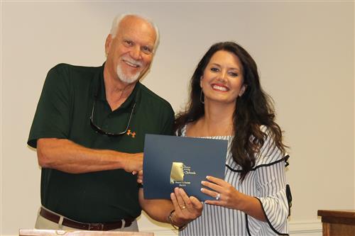 Mike Almaroad presenting a certificate of recognition to Shannon Finley 